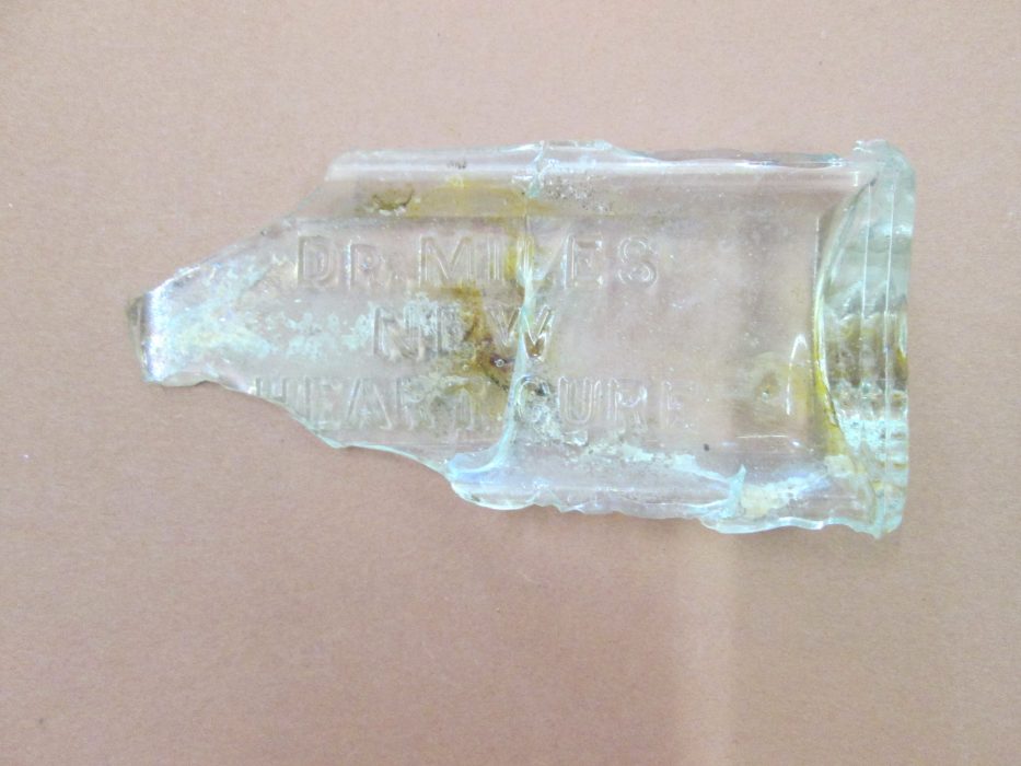 Glass bottle fragments found in excavation.